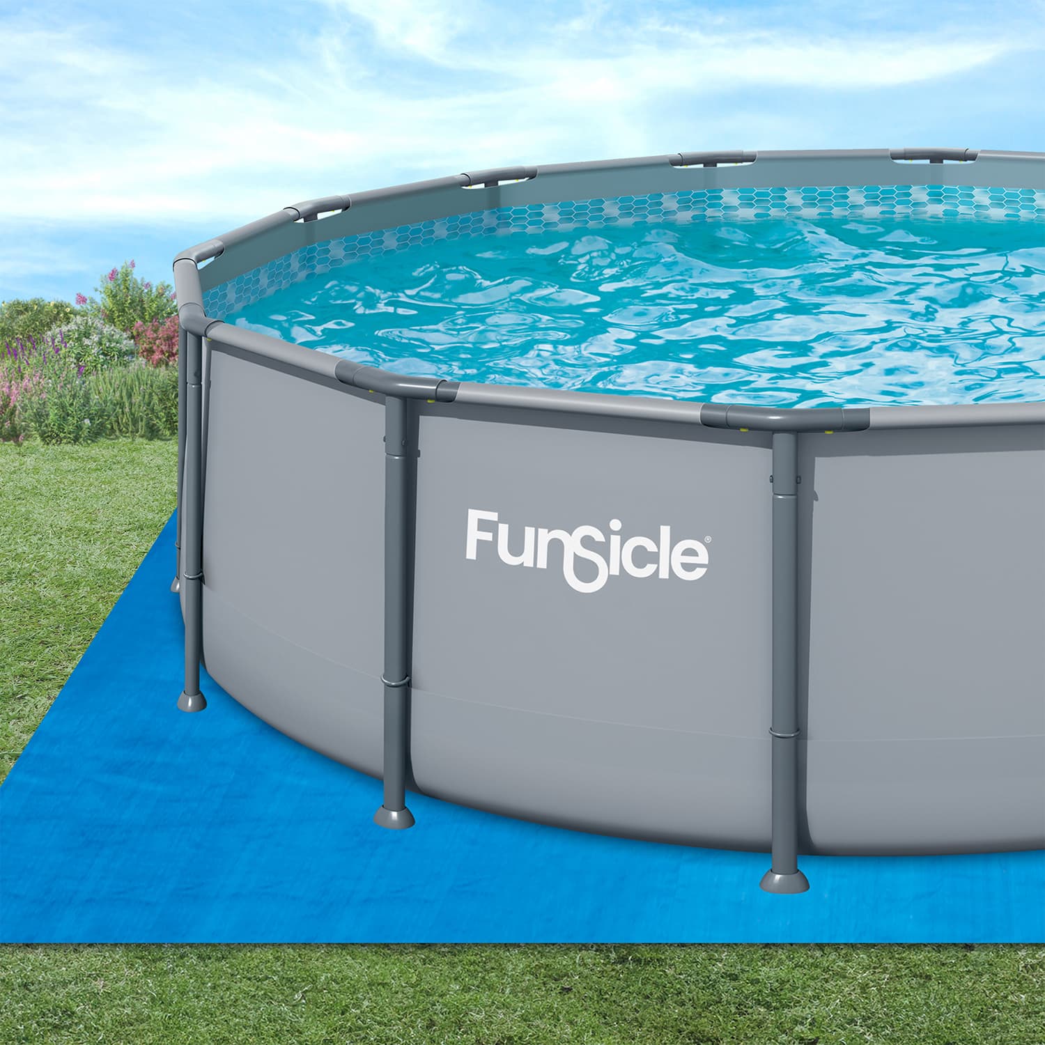 Funsicle above-ground pool on a blue ground cover with grass and flowers in the background