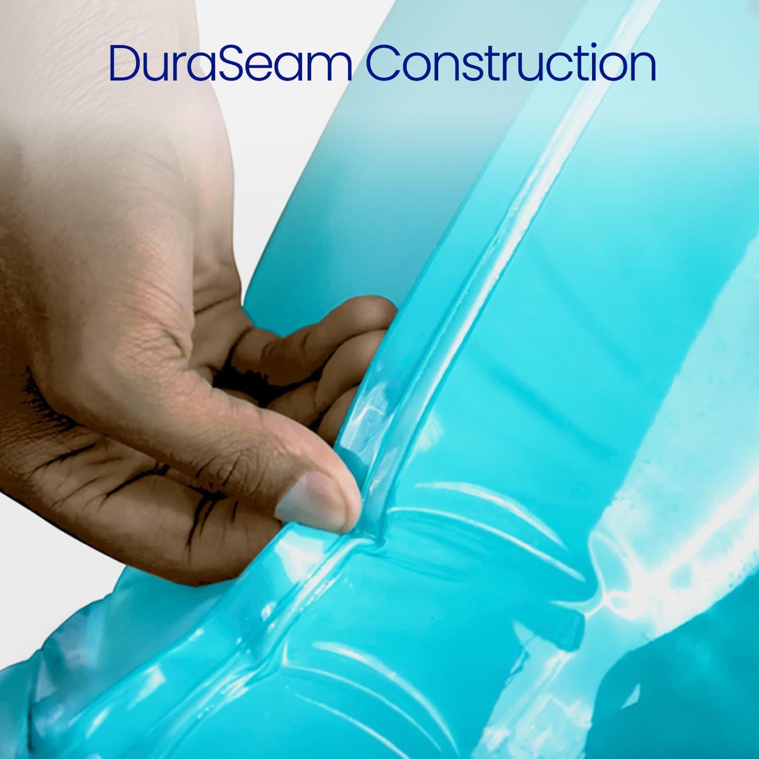 Close-up of a hand holding a blue inflatable pool with 'DuraSeam Construction' text.