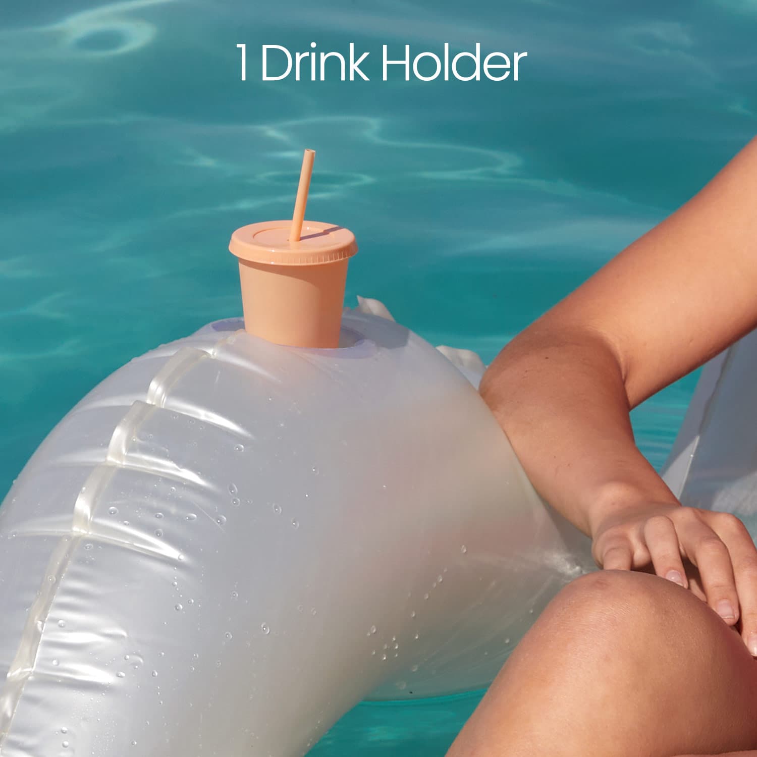 Inflatable drink holder with a peach-colored cup and straw in a pool setting.