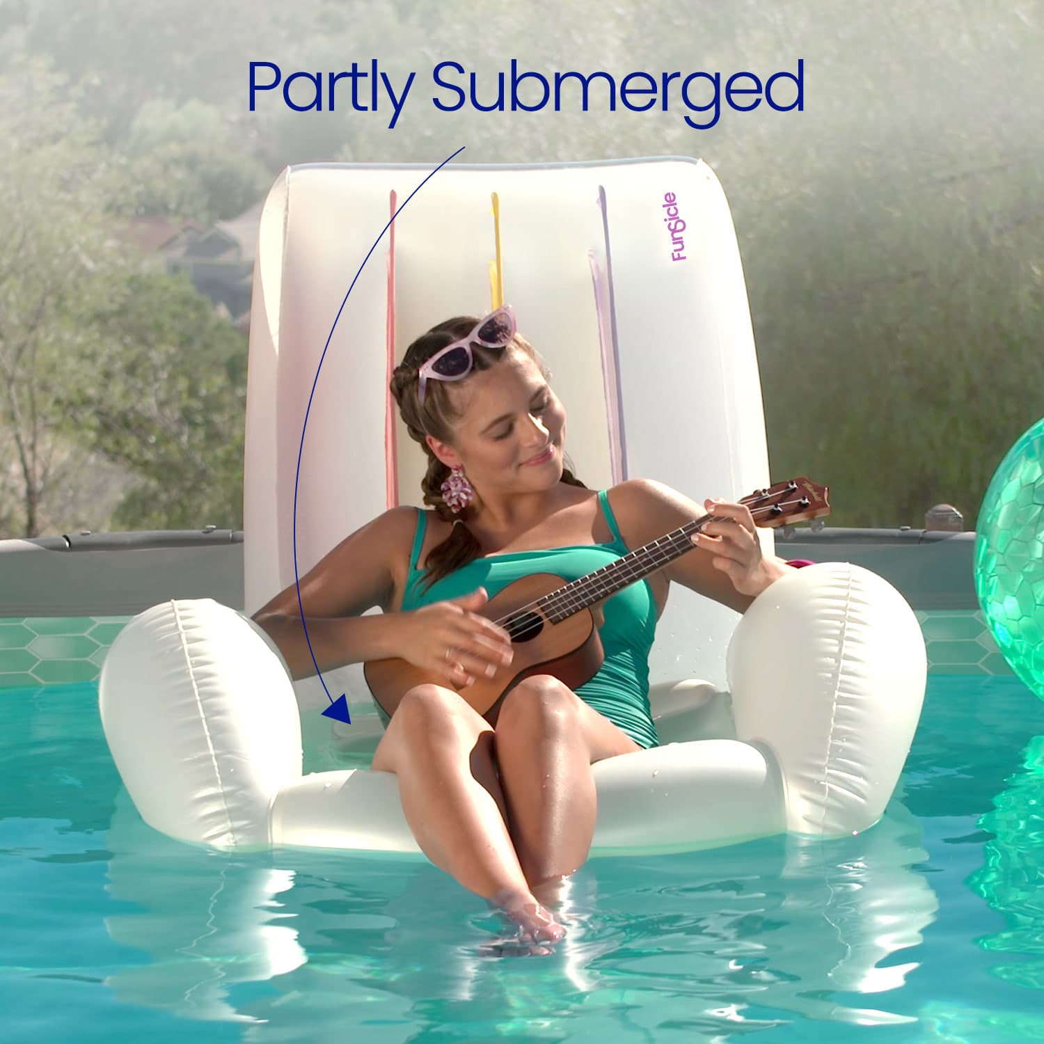 Woman playing a ukulele on an inflatable pool chair partially submerged in water with 'Partly Submerged' text above.