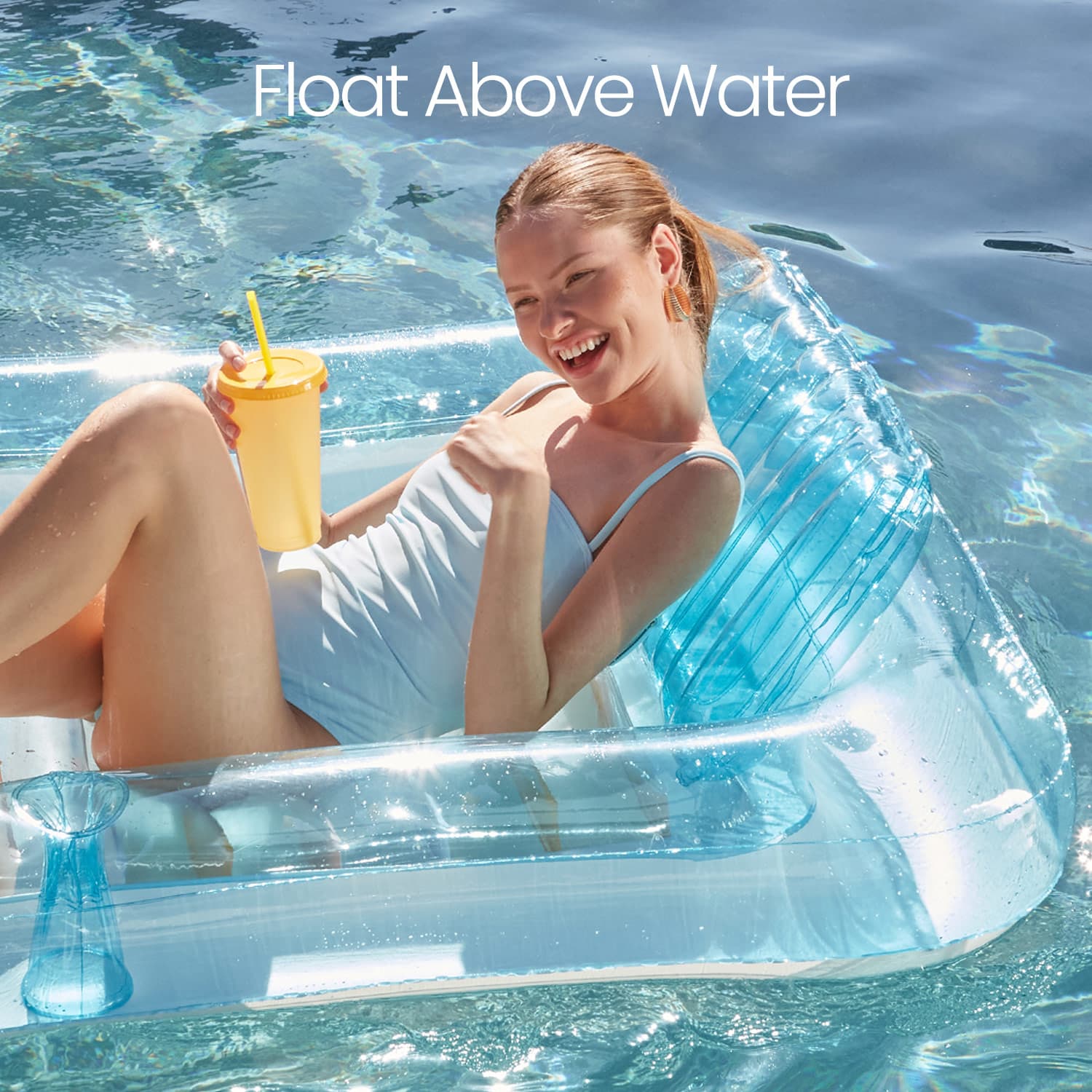 Woman lounging on a clear inflatable pool float with a yellow cup, surrounded by water.