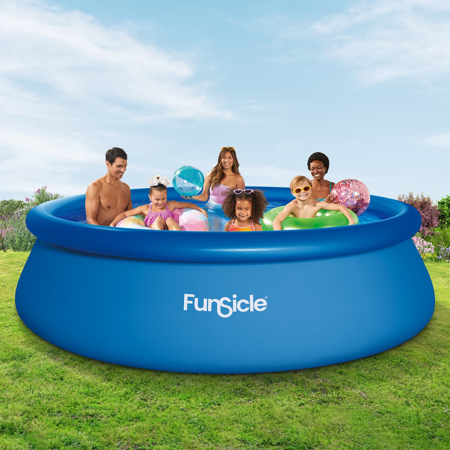 Family playing in a blue inflatable pool with 'FunSicle' branding on a grassy area.