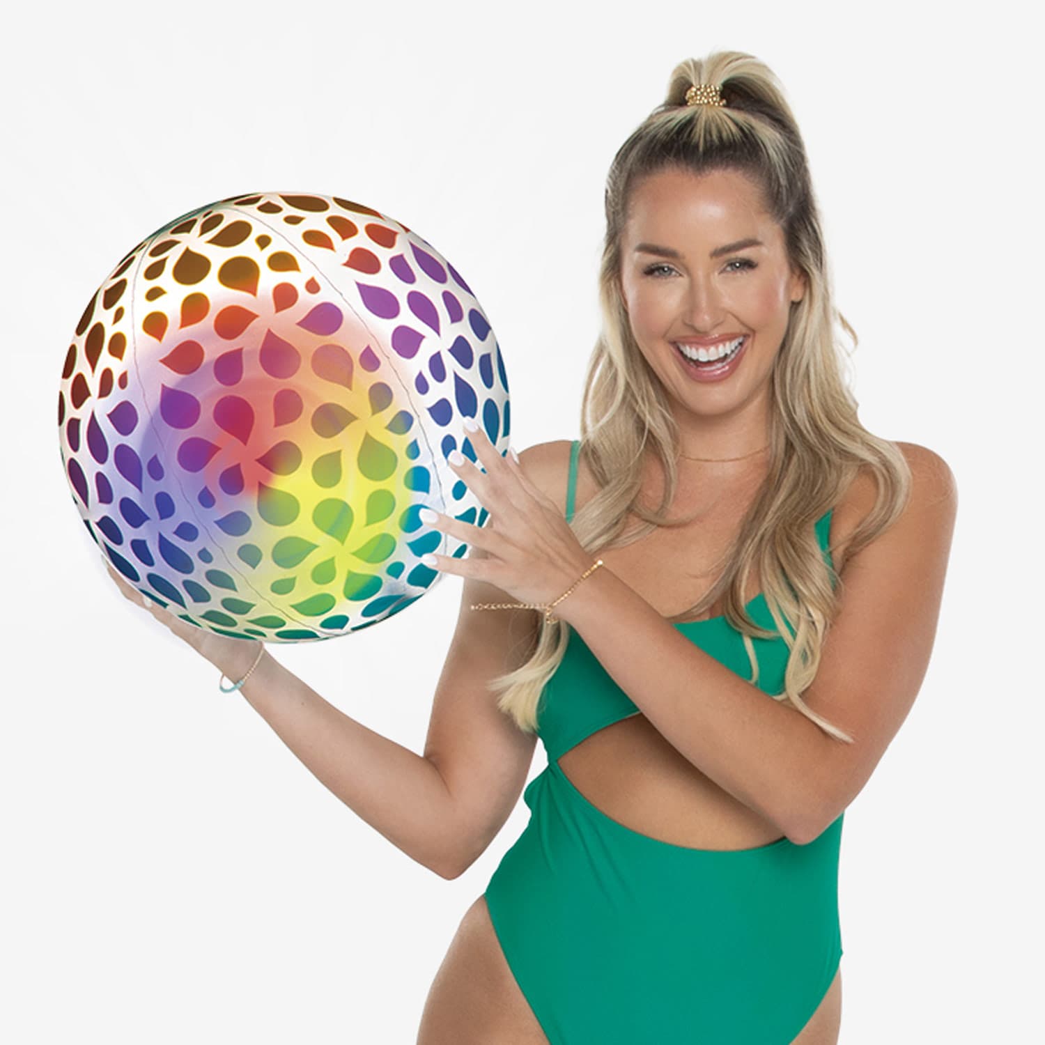Woman in a green swimsuit holding a colorful beach ball against a white background