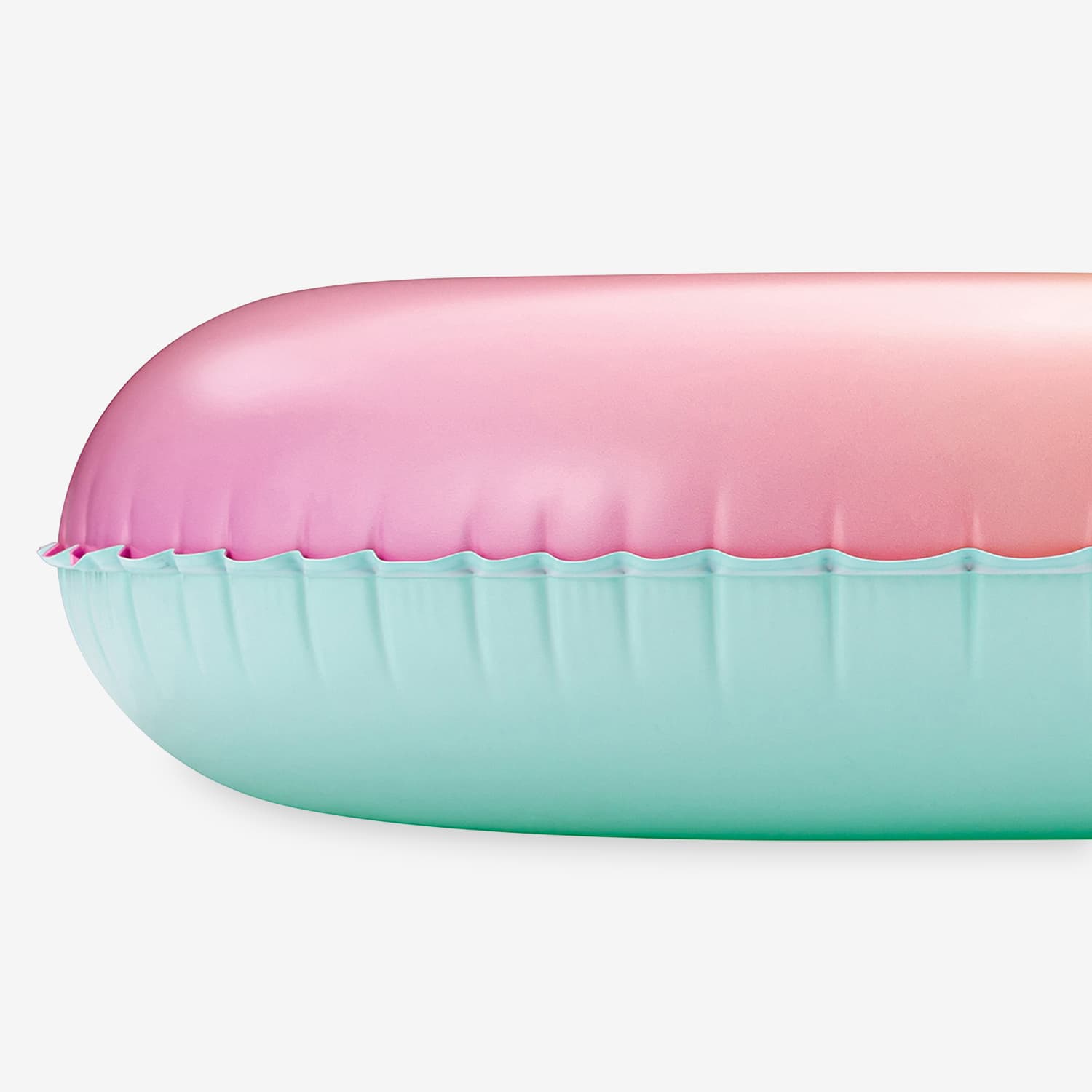 Inflatable pool ring with pink top and blue bottom on a white background
