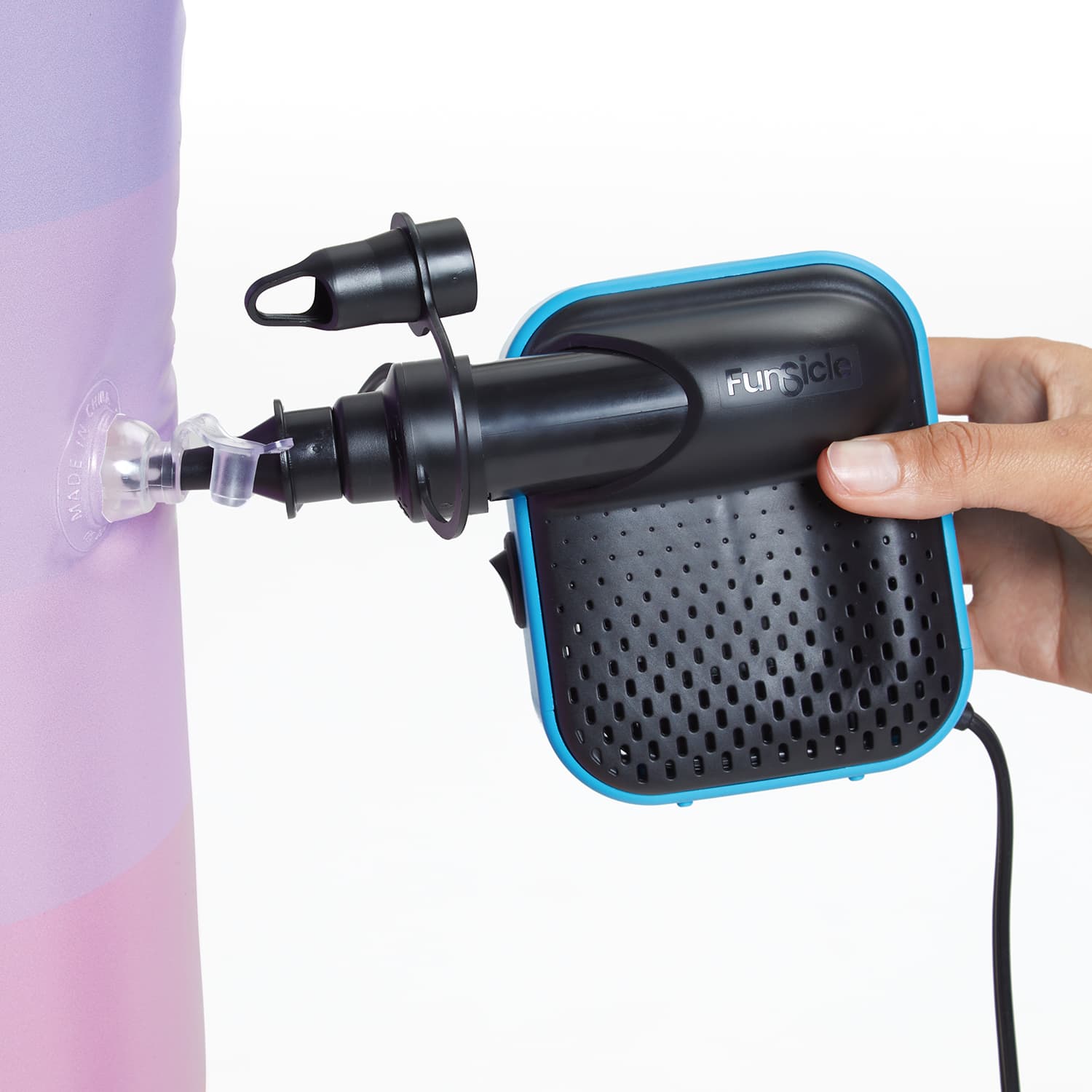 Black and blue electric hand air pump with a hand holding it, attached to an inflatable