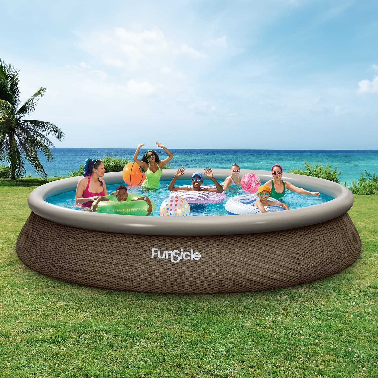 Funsicle inflatable pool with people playing in a grassy area by the ocean.